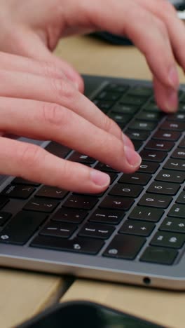 hands typing on a laptop keyboard