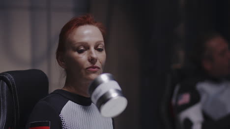 woman in spacesuit examining a can