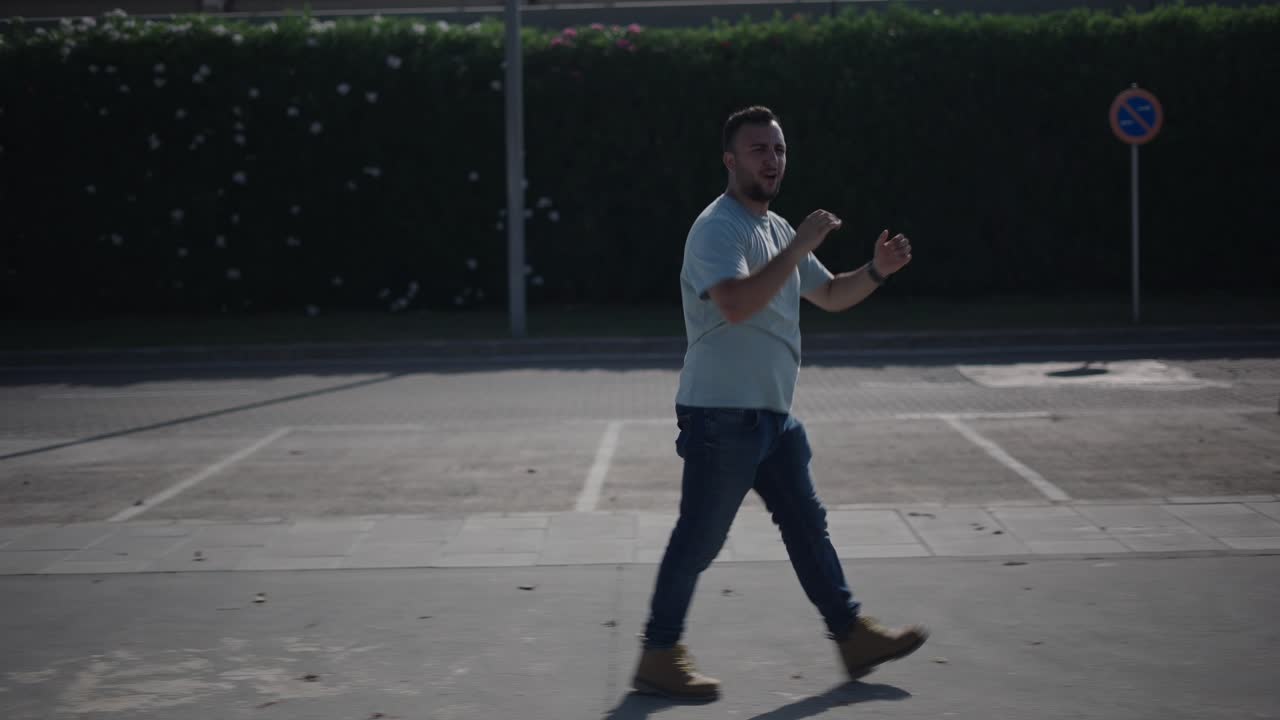 Man Walking and Dancing on a Street