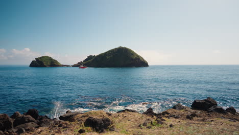 slow motion view of villa franca do campo island from the rocky shore of sao miguel in the azores - portugal