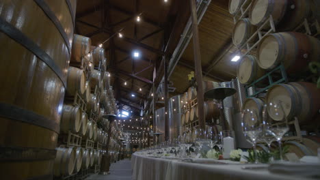 Wedding-reception-feast-location-in-the-interior-of-a-winery-barrel-room