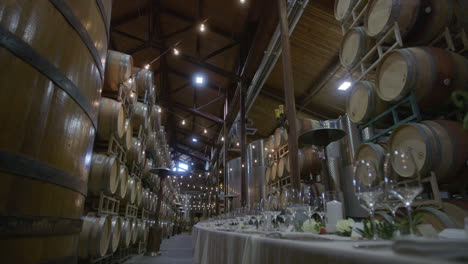 wedding reception feast location in the interior of a winery barrel room