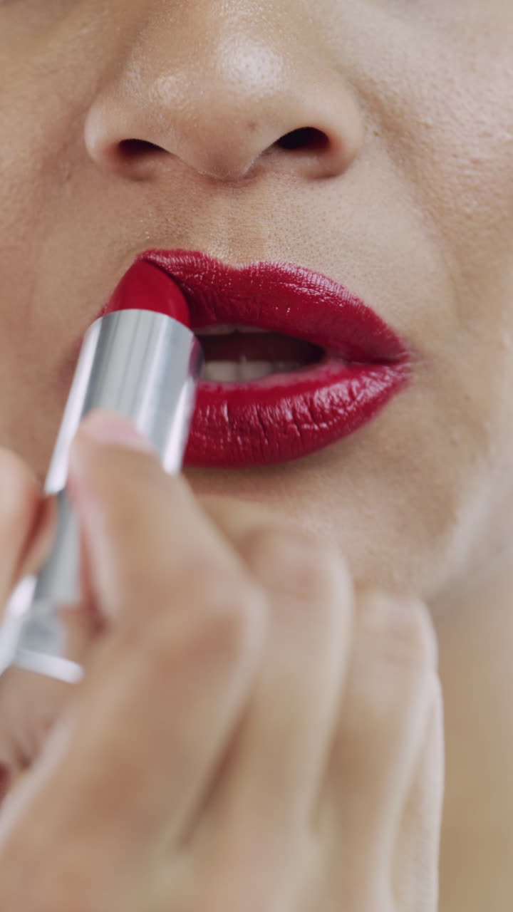 Close-Up of Woman Applying Red Lipstick to Her Lips
