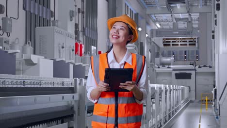 female engineer inspecting a production line