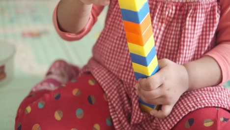 toddler playing with building blocks