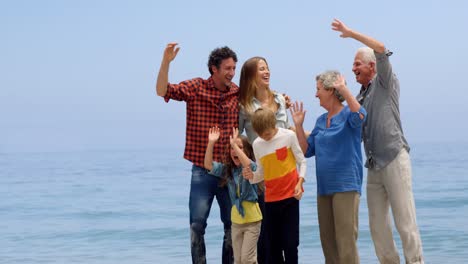 Multi-generation-family-jumping-on-the-beach