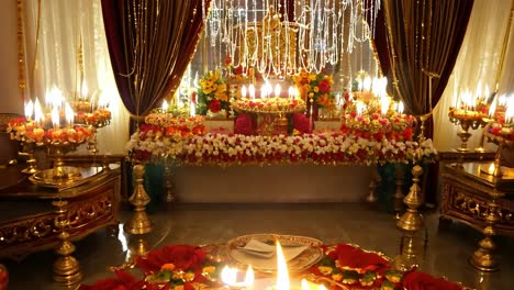 a traditional indian hindu altar decorated with flowers and candles