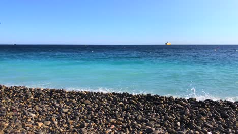 beautiful pebble beach with calm ocean waves