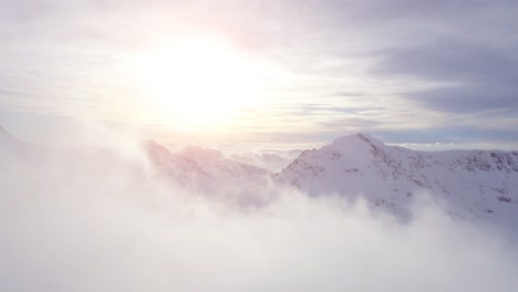 snowy mountain peaks above the clouds