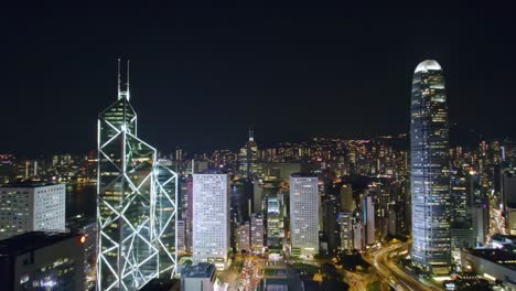experience the breathtaking view of hong kong's skyline at night. tall skyscrapers shine brightly against a dark sky, showcasing the city's vibrant urban landscape and bustling atmosphere.