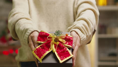 close up of young woman showing gift box