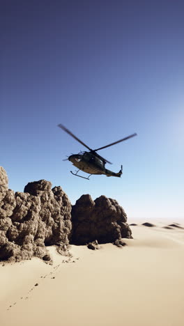 military helicopter flying over the desert