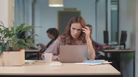 business woman reading correspondence. serious woman working at open space.