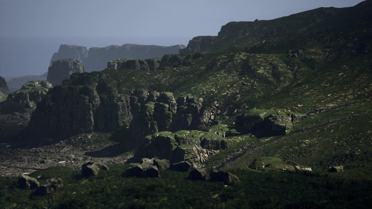 Rocky cliffs and green hills near the ocean at midday in a serene landscape