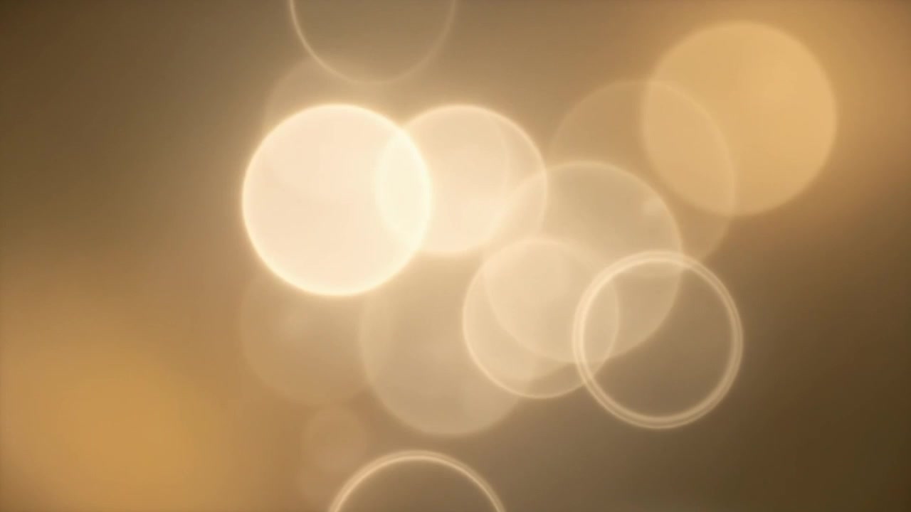Abstract Golden Light Bokeh Background with Floating Particles