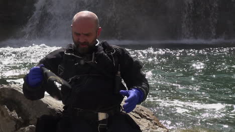 Male-technical-scuba-diver-gears-up-for-chaotic-river-waterfall-dive