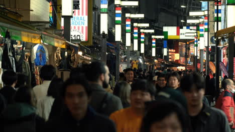 many pedestrians walk at shibuya famous crossing street in tokyo, japan.