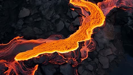 aerial video captures vibrant, flowing lava over dark rocks, showcasing nature's raw power