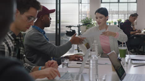 creative-team-meeting-marketing-manager-woman-sharing-project-documents-discussing-information-with-colleagues-in-multi-ethnic-office