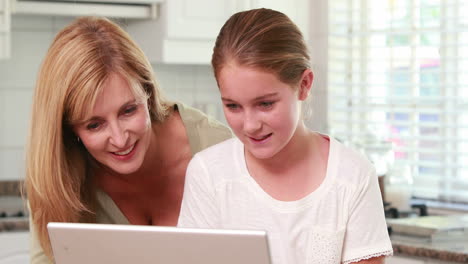 mother and daughter using laptop together