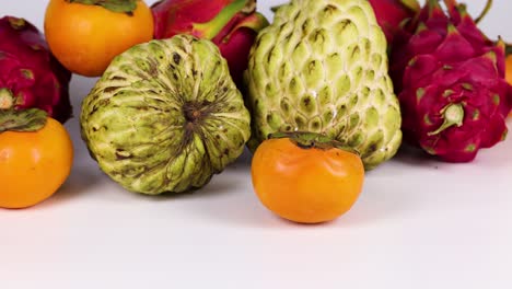 assorted fruits displayed on a white surface