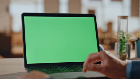 las manos de un trabajador independiente deslizando la computadora portátil chromakey en el despliegue de la oficina. hombre leyendo noticias