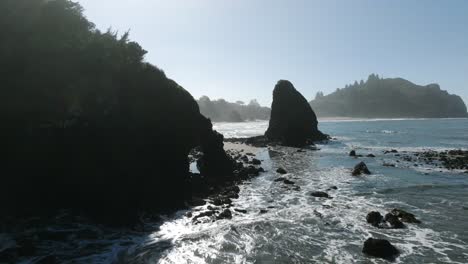 epic aerial of northern california coastline with rocks, cliffs, forest and waves