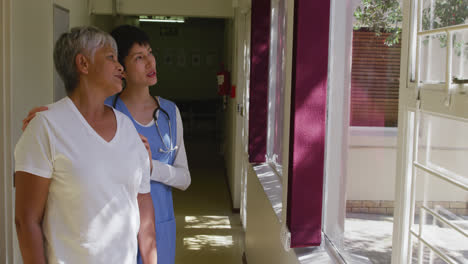 nurse helping a senior woman in a retirement home