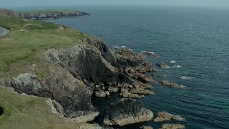 Aerial-dolly-in-of-beautiful-cliff-by-the-seacoast-on-calm-day