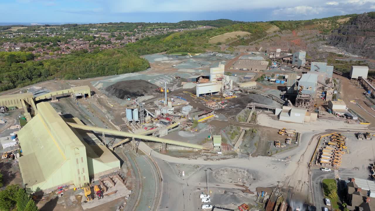 Wide drone view of open pit quarry in Coalville England with industrial layout and mineral extraction activity