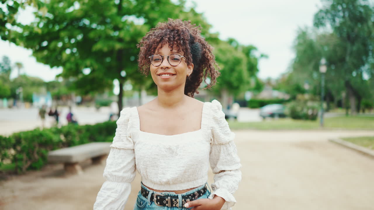 Woman with curly hair in park
