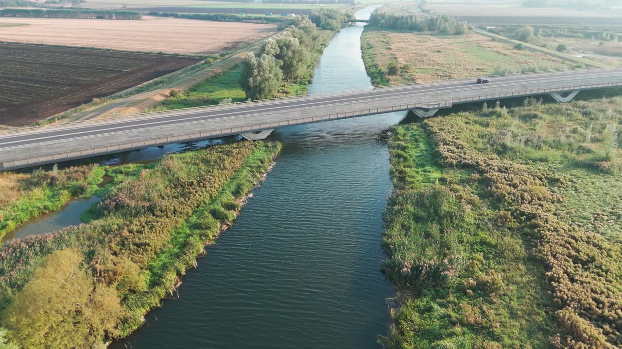 Aerial View of a Highway Bridge Over a Canal in the Countryside