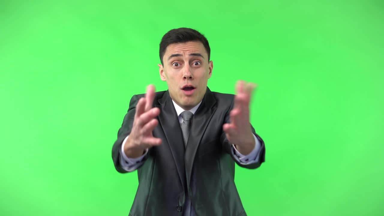 Businessman expressing various emotions on green screen