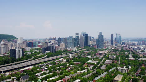 aerial view backwards over the petite-bourgogne district, in sunny montreal, canada