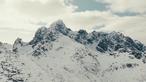 rugged mountain peaks in snow during winter near svolvaer, norway. aerial drone shot