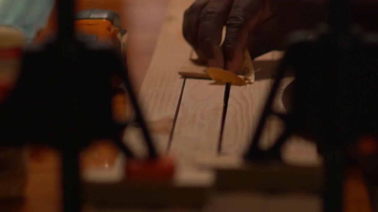 African American Man Sanding Wood
