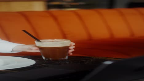 cafe interior with orange couch and coffee