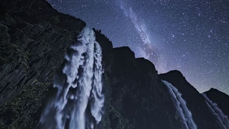 waterfall under a starry night sky