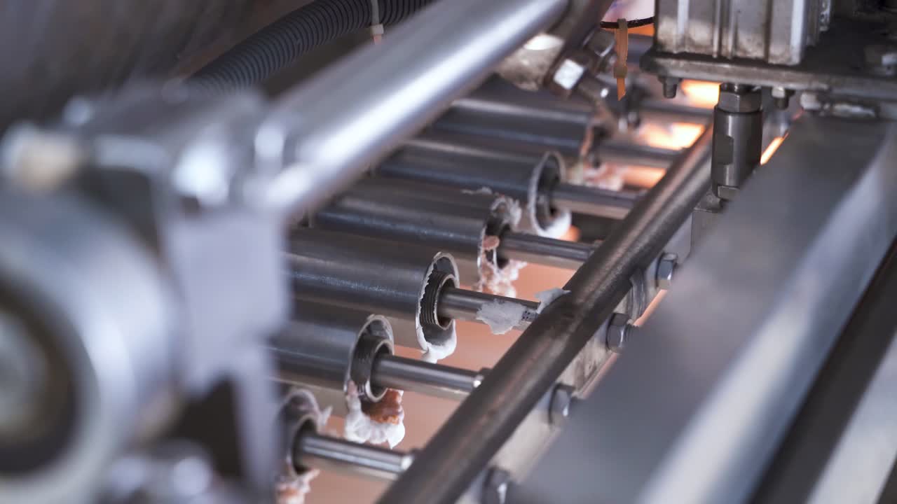 Pistons extruding cream for the production of marshmallows. Mechanism at the confectionery factory. Close-up