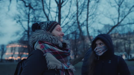 two friends bundled up against the cold, enjoying a winter walk in riga, latvia