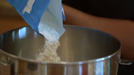 shifting flour into a mixing bowl to make bread dough - slow motion