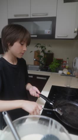 boy cooking pancakes