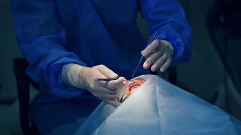 doctor treating the patient eyes. ophthalmologist operating eye of patient in medical clinic