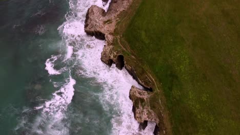 Aerial-view-of-Praia-das-Catedrais-famous-landmark-in-north-Spain-,-natural-rock-formation