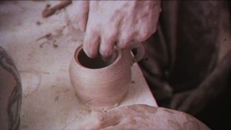 young woman makes a jug of clay. female hands mold pottery