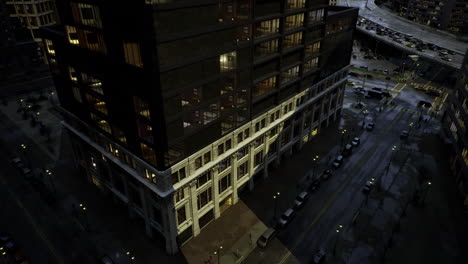 urban building illuminated at night with street activity captured in view