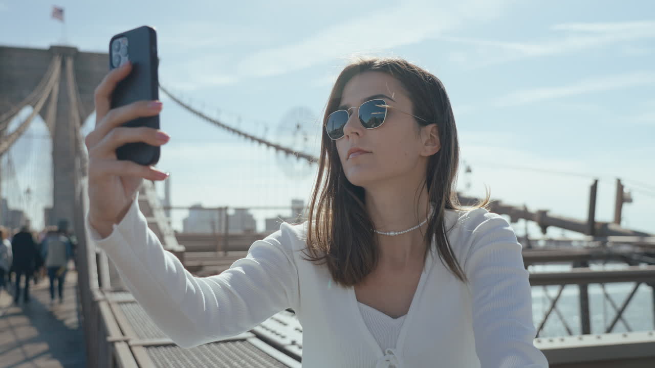 Woman taking a selfie on the Brooklyn Bridge