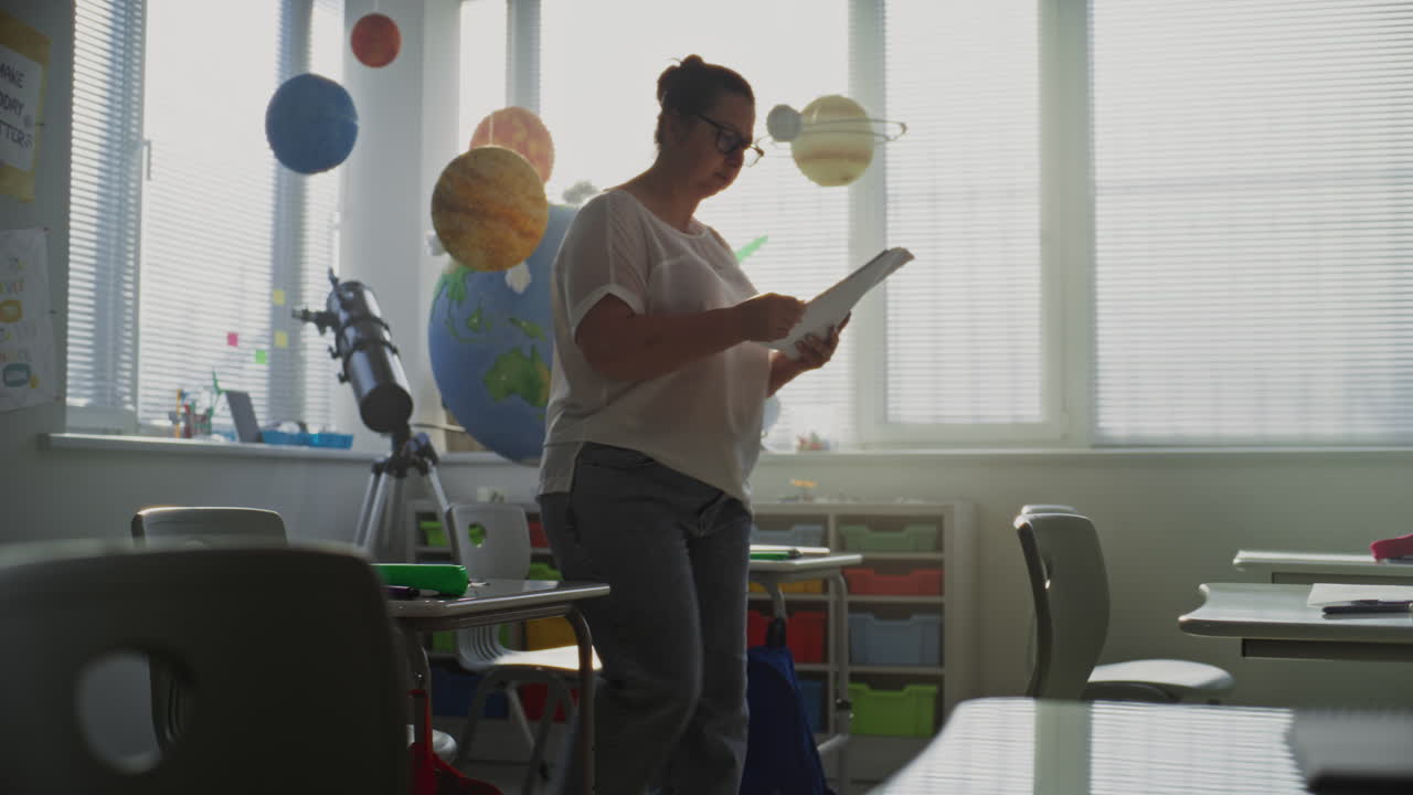 Classroom scene with teacher and planets