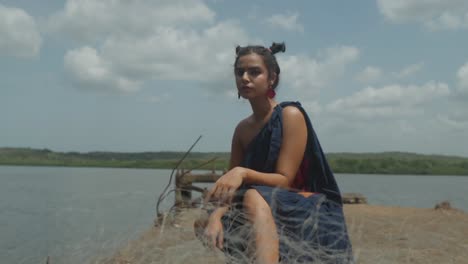 close view of woman's face reflects sensuality as she expresses deep concern for environmental issues, showcasing her awareness and compassion for the planet's well-being with blue sky in background