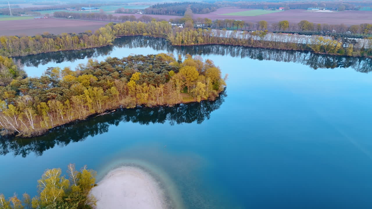 Peaceful Dutch Water View. Aerial view of a serene lake in the Netherlands surrounded by lush greenery and peaceful reflections during sunset